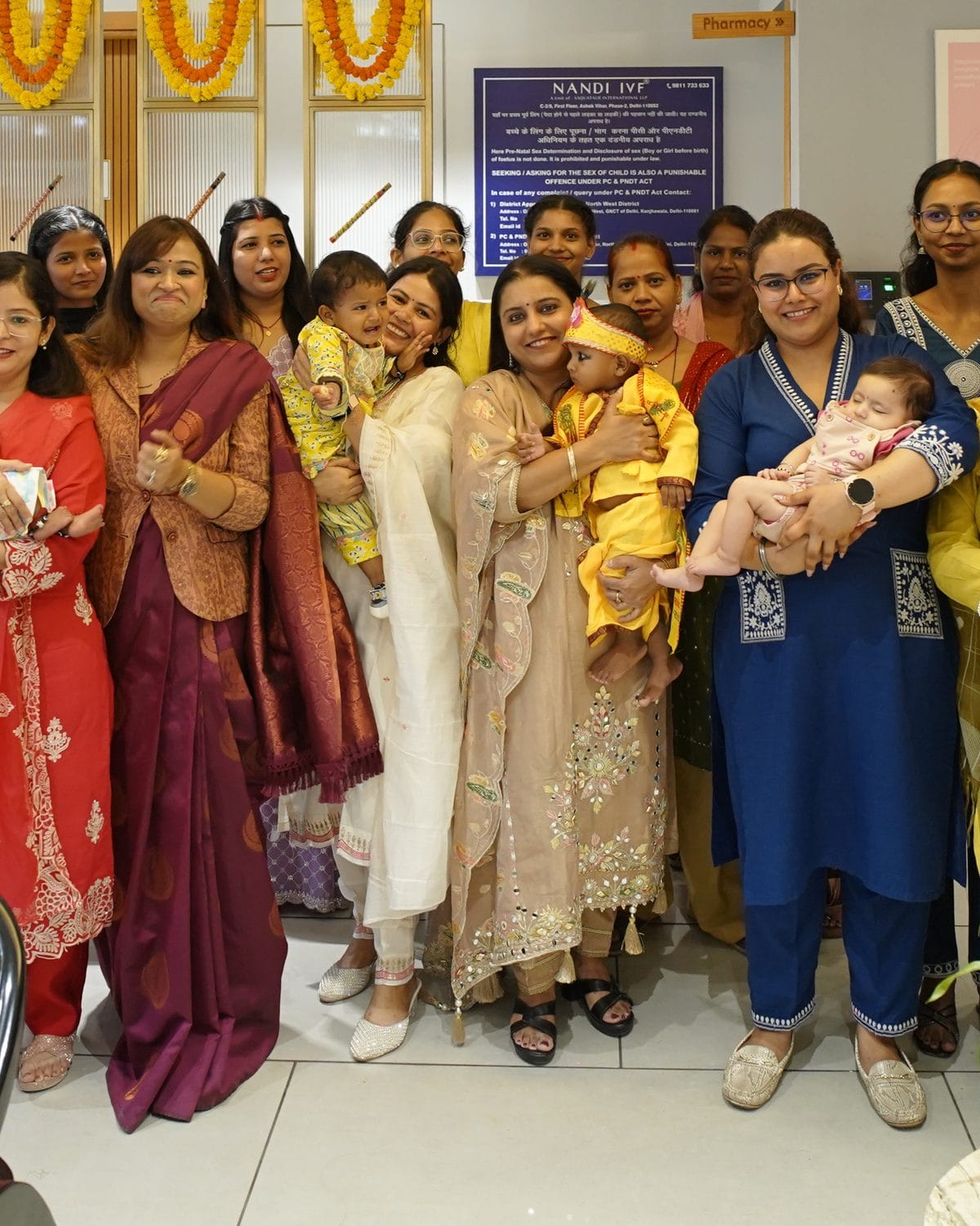 Families celebrating with their babies at Dr. Payal Bajaj's clinic